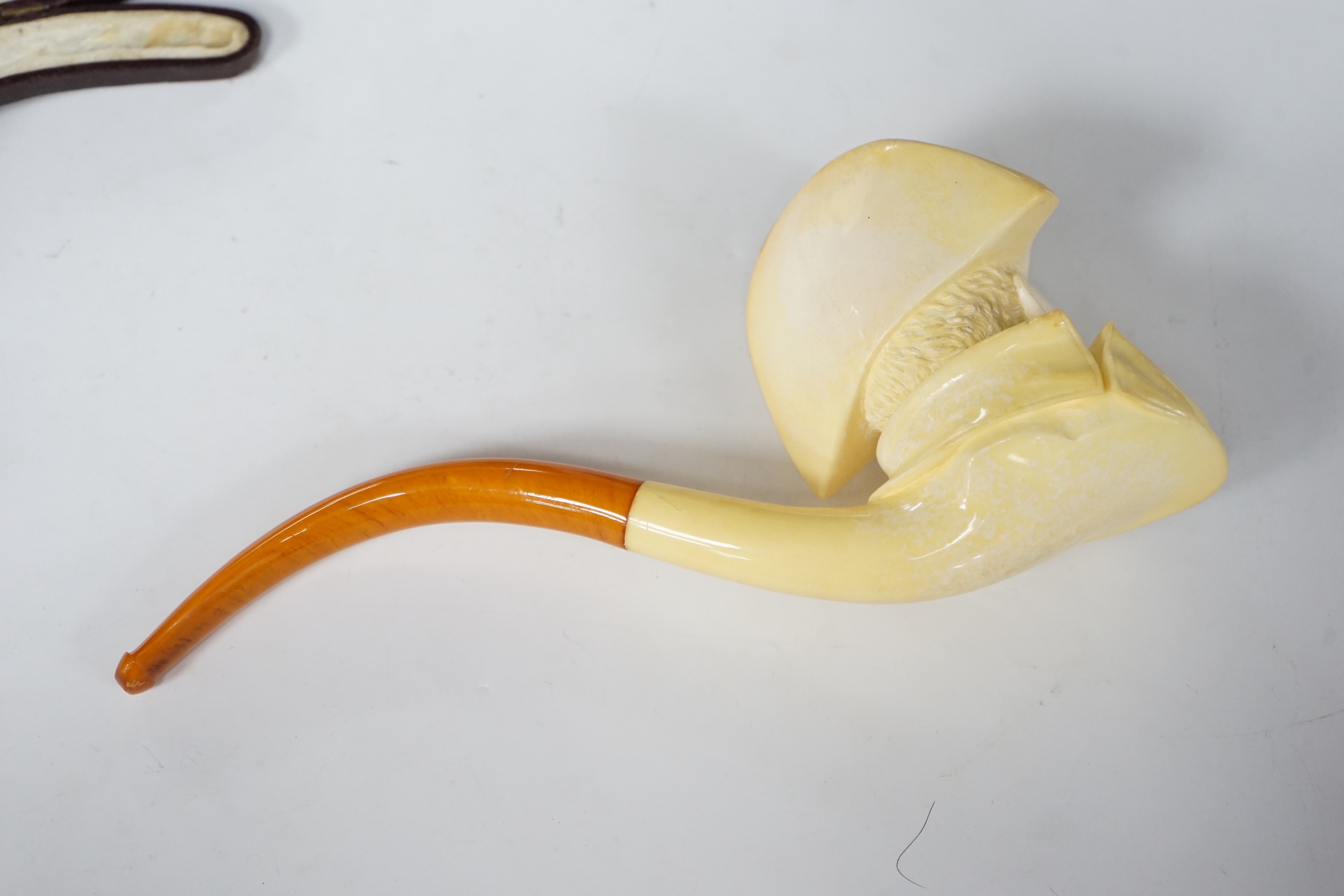 A large cased Meerschaum ‘Napoleon bust’ novelty pipe, early 20th century, with amber mouthpiece, 24cm long